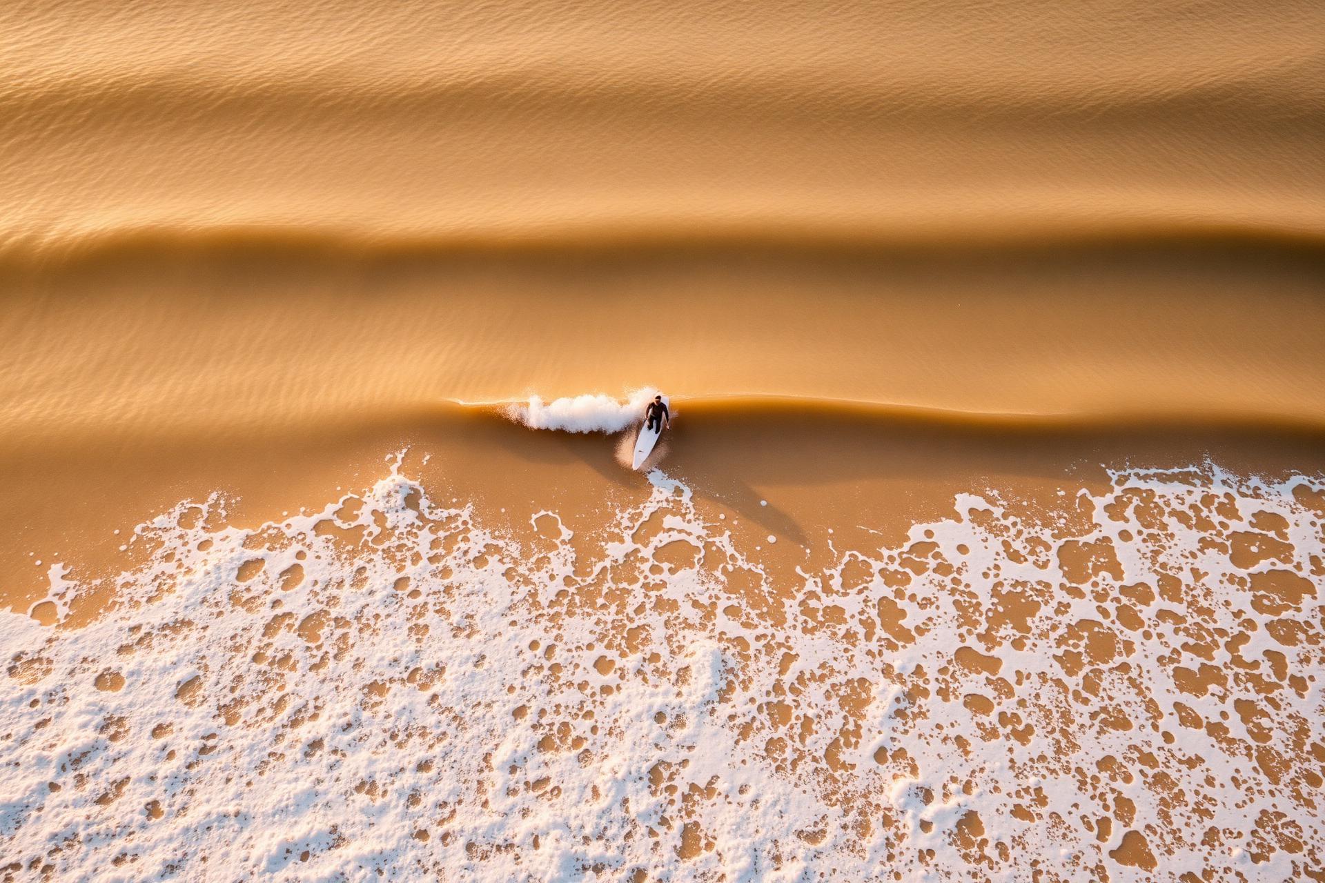 Aerial view of a surfer at golden hour in Taghazout